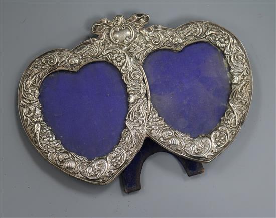 A late Victorian repousse silver mounted double heart shaped photograph frame, London, 1982, width 23.5cm.